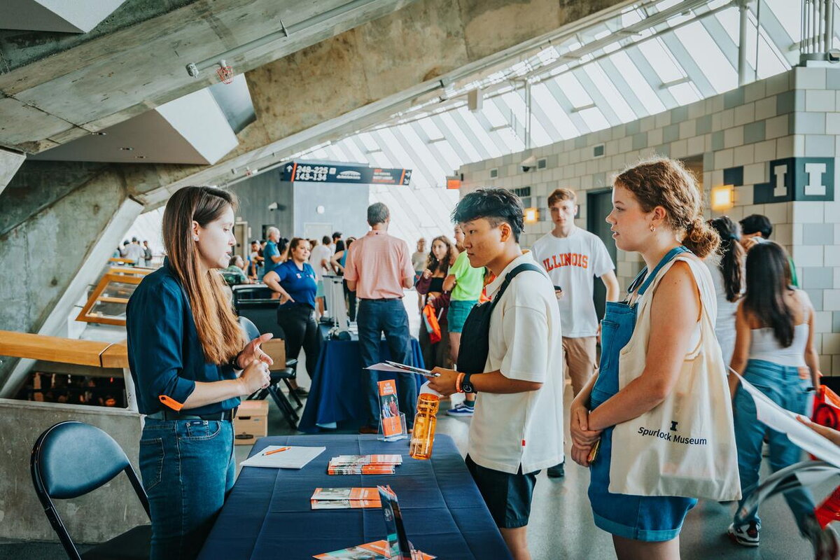 students visiting an information booth
