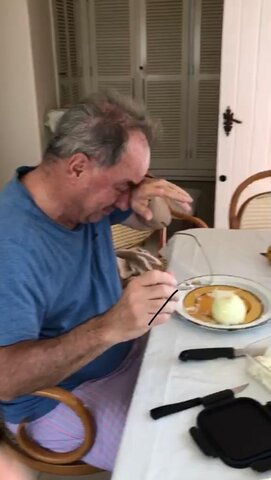 Family member in Brazil peeling onions