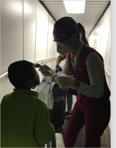 Airport personnel taking passenger temperatures