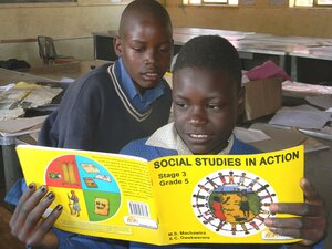 Harare, Zimbabwe, October 18 2015. Primary school children reading a Social Studies book inside a classroom. Social studies is one of the important subjects at primary school.